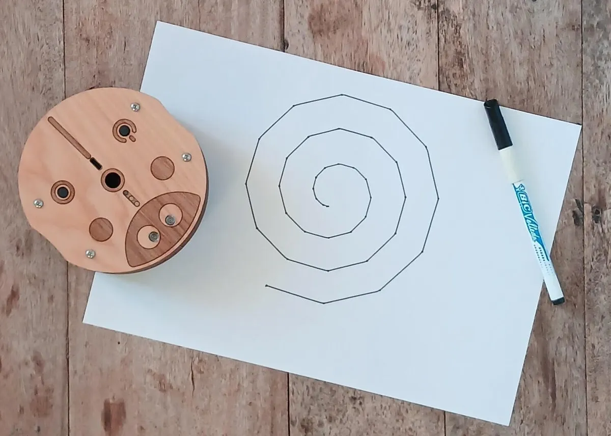 Robot drawing a spiral on paper